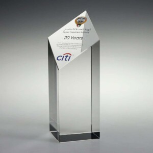 A sleek, transparent recognition award with a triangular top and a rectangular base, featuring logos of citi and kuwait investment authority and text celebrating 20 years of partnership.