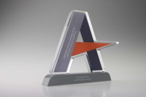 A sleek, modern recognition award with a star-shaped design in shades of blue and orange, standing on a rectangular base. it's labeled 'renaissance amsterdam hotel - winter hotel award 2015.'.