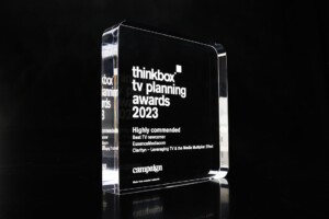 A clear acrylic recognition award on a black background, labeled "thinkbox tv planning awards 2023" for "best tv newcomer" and mentioning "highly commended.