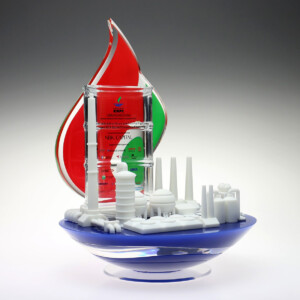 3d refinery deal toys sculpture made of 3d prints, including markers, container lids, and building toy parts, predominantly in red, green, white, and blue tones, on a light background.