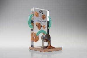 Deal toys display features a mechanical handle turned to dispense molten metal from a silver container adorned with branding and product information.
