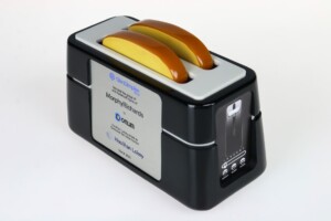 A morphy richards quantum bread maker deal toy device on a white background, showcasing its compact black exterior and a distinctive yellow and orange lid.