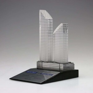 A model of a building on a financial tombstones black base