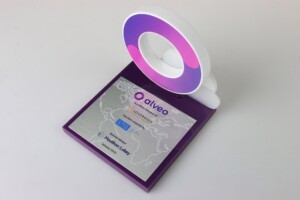 Financial tombstones with a machined white ring on a purplae base with a metal plate with the text and logos printed