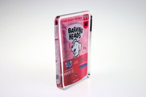 Financial tombstones of barking heads dog food with a cartoon dog illustration, predominantly in pink and red colors, displayed against a white background.