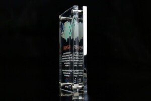 Clear acrylic financial tombstones with a black background.