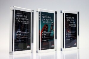 Three financial tombstones in a row advertising citi, each featuring a different person and the slogan "the only numbers that grow more than the bottom line.