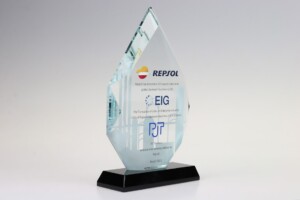 Transparent, leaf-shaped financial tombstones with a black base, featuring logos and text celebrating a corporate partnership between repsol, eig, and pjt, dated march 2022.