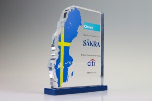 Acrylic financial tombstones with a blue and silver map design, featuring the logos of cinven, säkra, and citi, and text celebrating an acquisition milestone dated september 2022.
