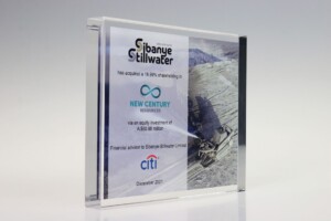 Financial Tombstones Sibanye Acrylic financial tombstones announcing sibanye stillwater's acquisition of a 19.99% stake in new century resources, with financial details included, displayed on a reflective surface.