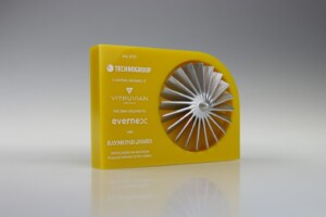 Yellow financial tombstones with a silver turbine blade design, announcing technogroup's acquisition by vitruvian as part of raymon james's portfolio in july 2020.