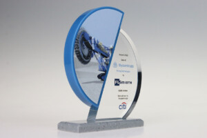 Clear acrylic half discs financial tombstones on a speckled grey base