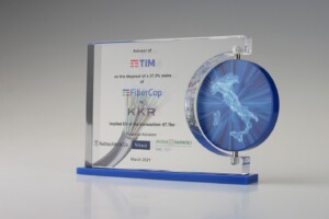 Clear acrylic financial tombstones on a blue base with a disc on the right side.