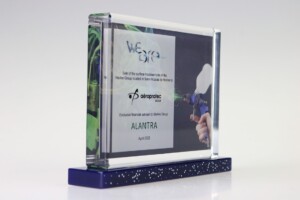 Clear acrylic financial tombstones with blue accents at the base, showcasing a logo, text regarding a financial deal, and the name "alantra" with a date of april 2022.